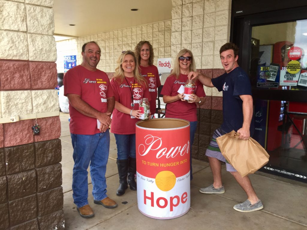 Photo of five White River Electric Cooperative employees raising support for local food banks