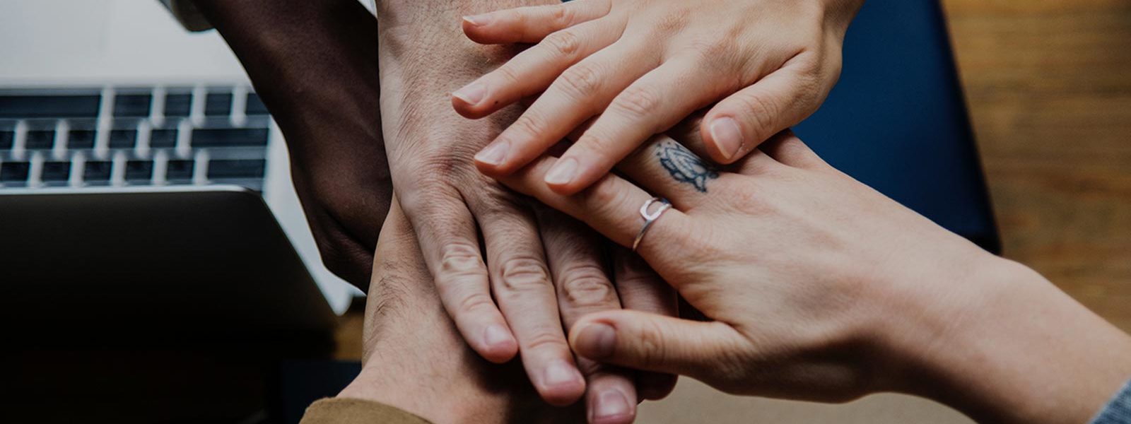 Photo of 5 hands laid one over the other