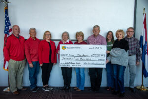 The White River Valley Electric Trust Board presents a check for $75,000 for local schoolteachers to use in their classrooms.